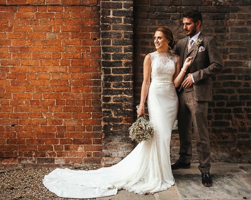 Bride and groom in rustic red brick setting